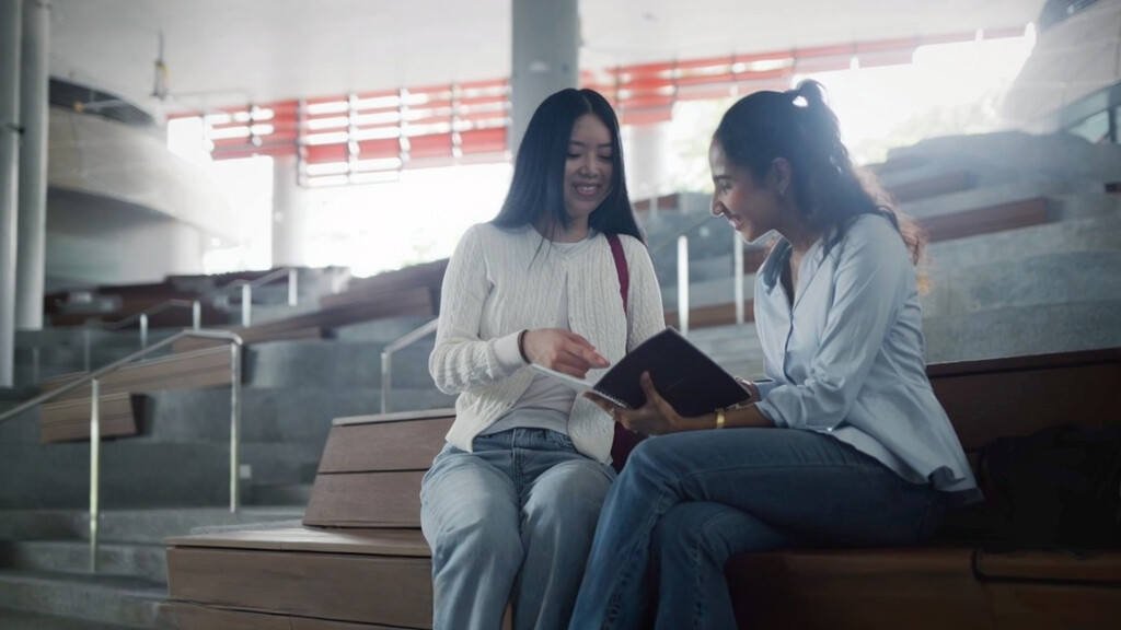 Corporate Video Production by Dreambox Studio. This scene was produced in SIT Punggol for CSCEC. The scene consist of a Chinese ethnic female student studying with an Indian ethnic female student in an open area within the campus.