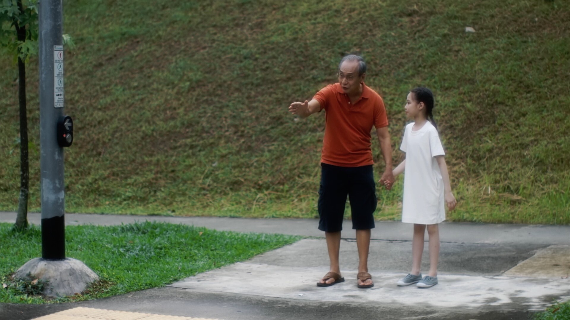 Dreambox Studio Advertising Video Production image. This image has an old asian grandpa and a young asian girl on the roadside.